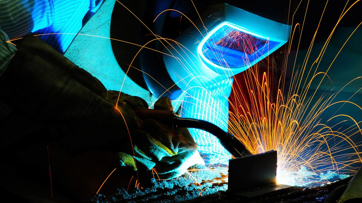 Welder working on a fabricated industrial component