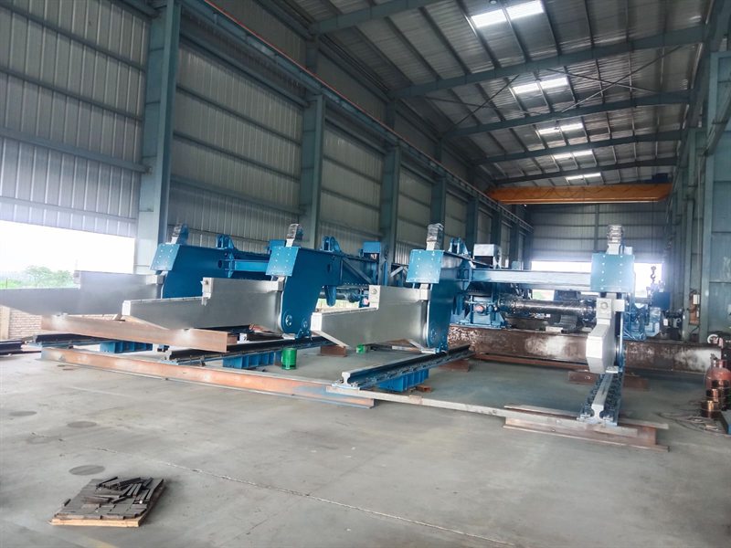 Large fabricated charging machine assembly inside a workshop